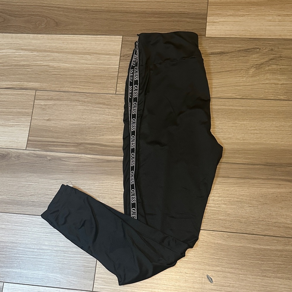 Woman sport wear.  Black Leggings yoga pants. with Side Guess branded Stripe.